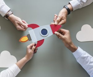 Business people with startup rocket